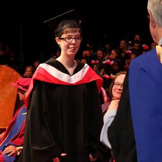 Julia receiving degree from John Black, Dean of Social Sciences